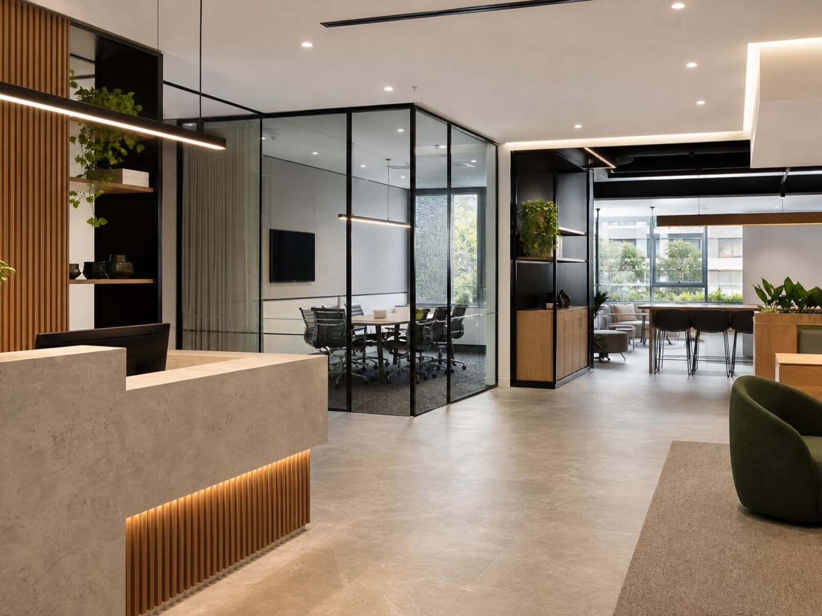 Commercial renovation image showing upgraded reception joinery, glass partitions, new flooring, and modern ceiling lighting.