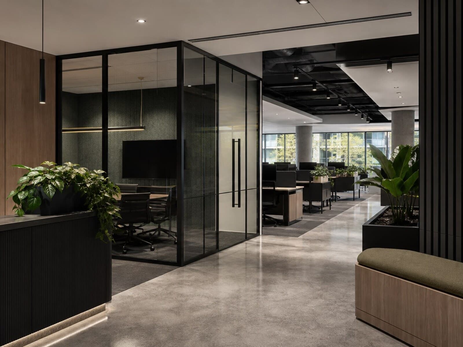 An open-plan Sydney office fitout with glass-partitioned meeting rooms, workstation clusters, integrated lighting, and a refined reception area.